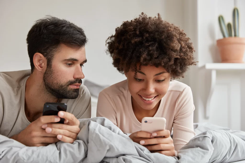 A man and a woman looking at a cell phone