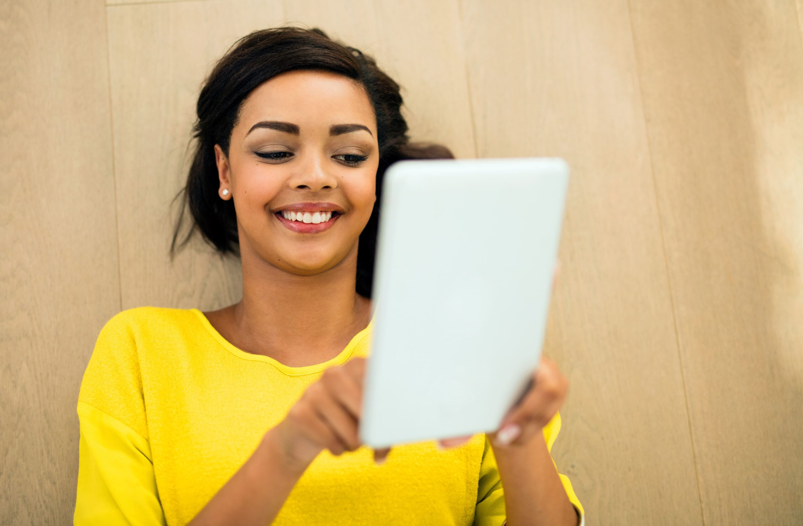 Entrepreneur reviewing Master Resell Rights documentation on a tablet.