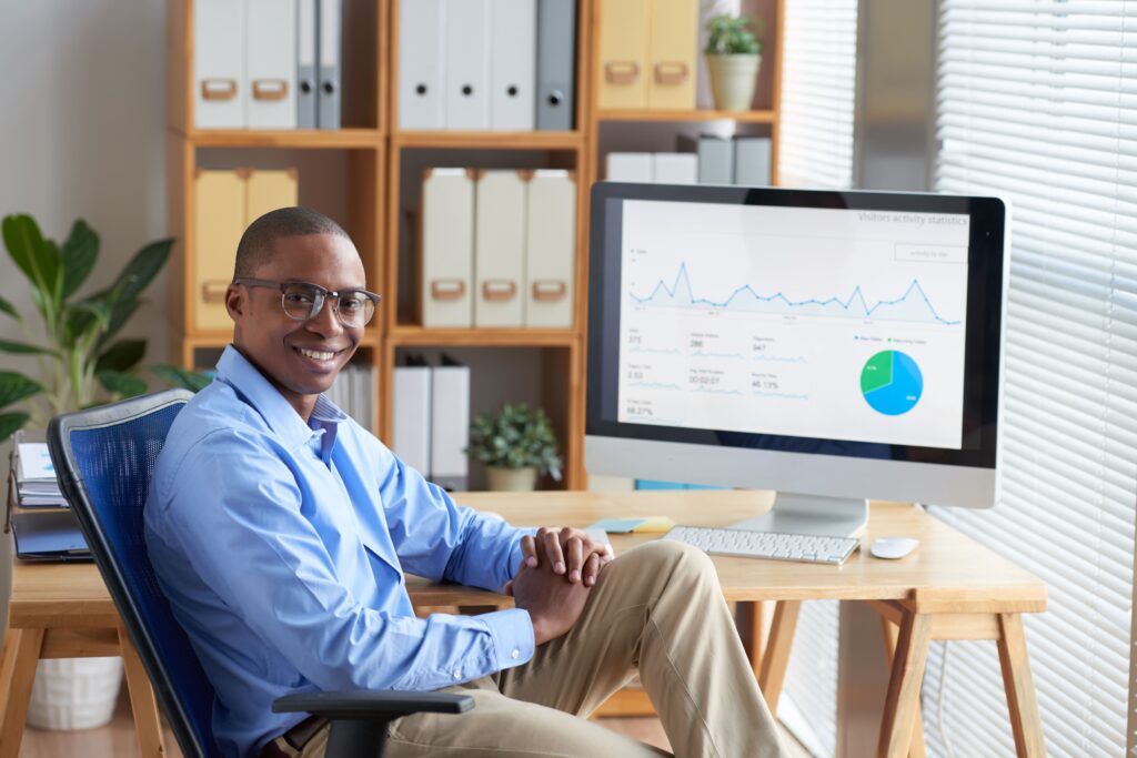 Business professional analyzing Google Ads performance metrics on a desktop screen.