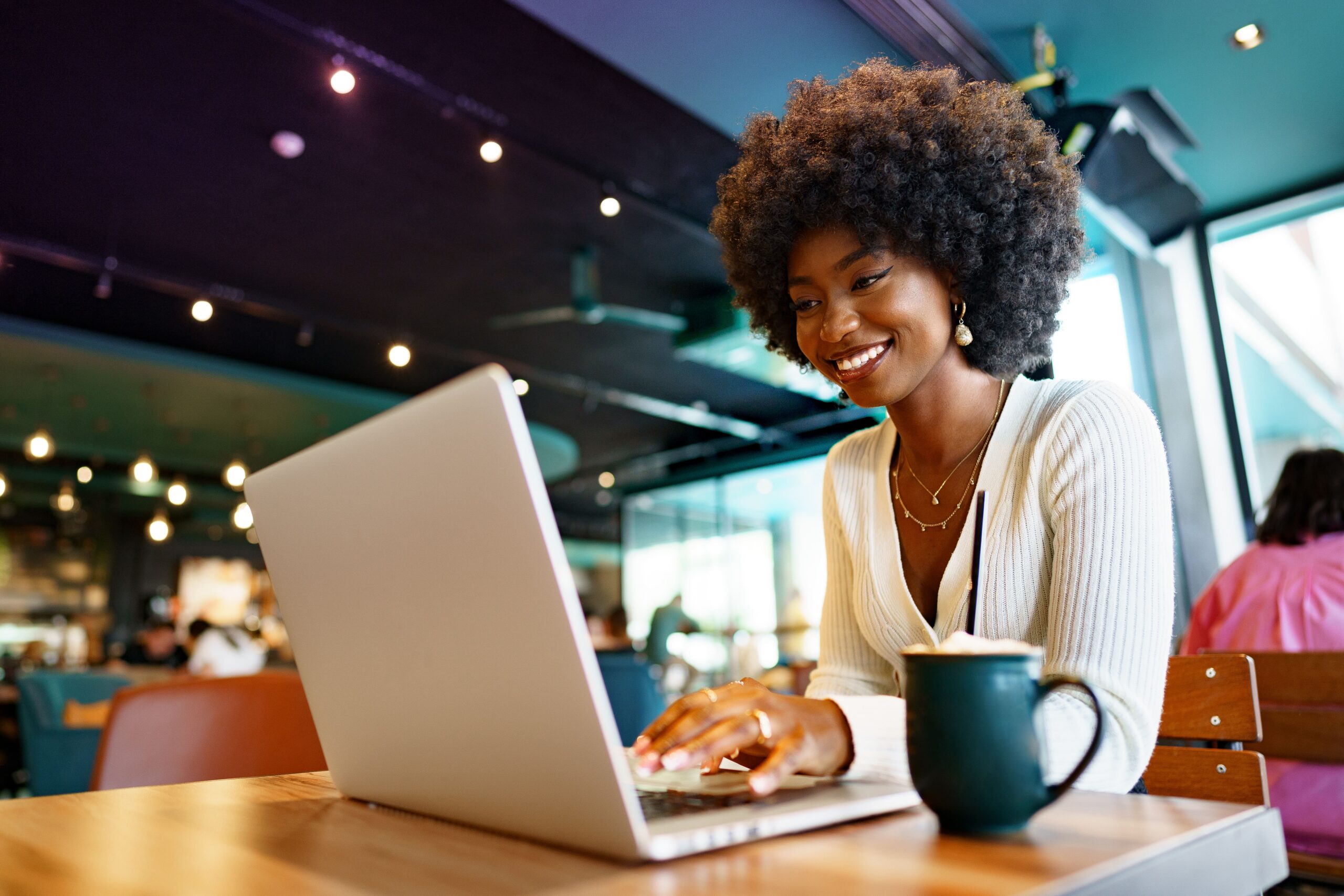 African-American Content creator working on a listicle in a café