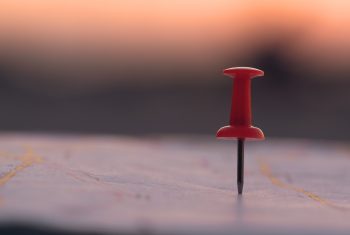Red pin marking a location on a map, representing Google Maps Optimization Services.
